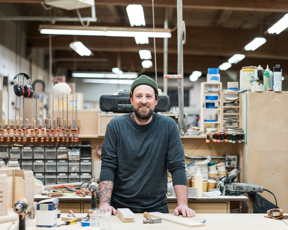 Carpenter standing at his workbench in a wood shop